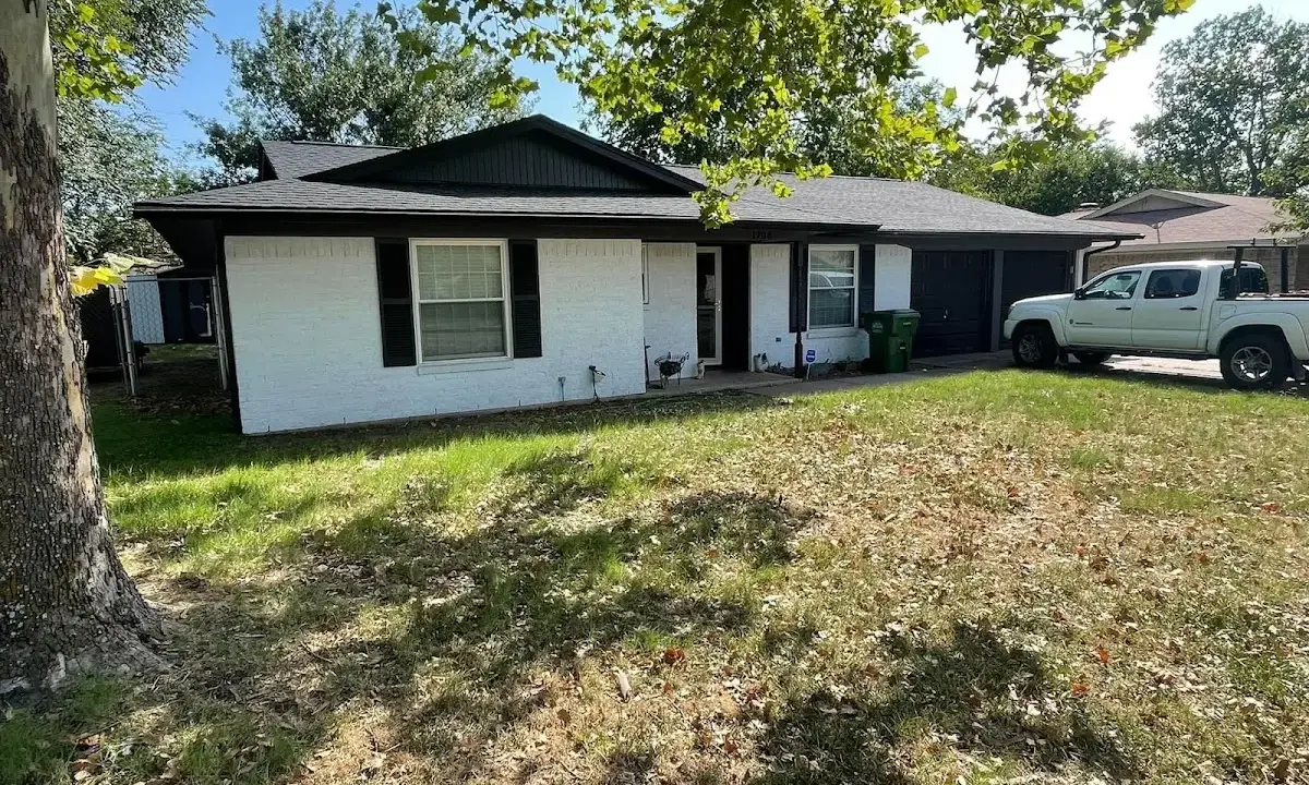 Professional roofing crew working on a residential roof in Weatherford